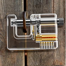 Square-profile transparent practice lock shown on a wooden mounting fixture